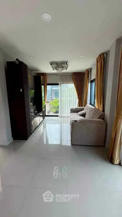 Spacious living room with modern decor and large windows offering natural light.