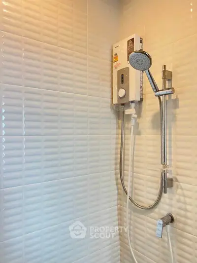 Modern bathroom with sleek shower and white textured tiles