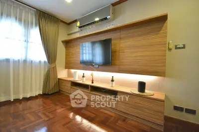 Stylish living room with wooden flooring and modern entertainment unit