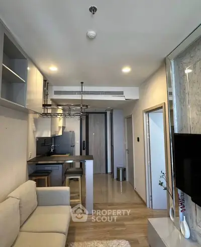 Modern open-layout living room with kitchen in stylish apartment