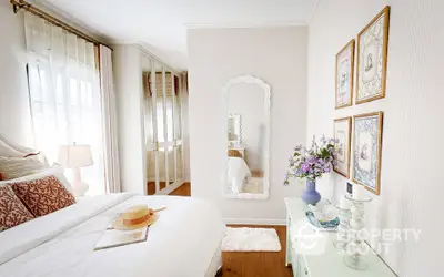 Charming bedroom with elegant decor and natural light, featuring a cozy bed and stylish furnishings.