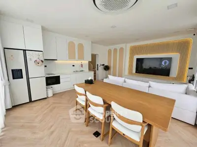 Modern open-plan living room with stylish kitchen and dining area