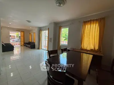 Spacious living and dining area with natural light and modern furnishings