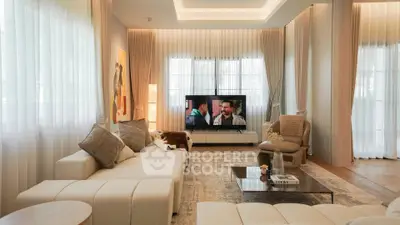 Luxurious living room with modern decor, plush seating, and large windows for natural light.
