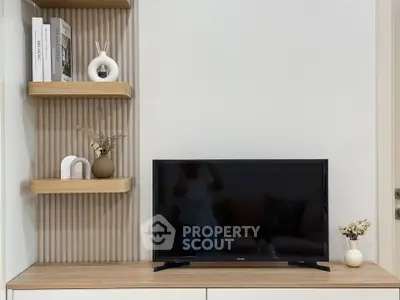 Modern living room with stylish shelving and flat-screen TV, perfect for contemporary home decor.