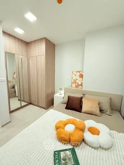 Cozy bedroom with modern decor and mirrored wardrobe