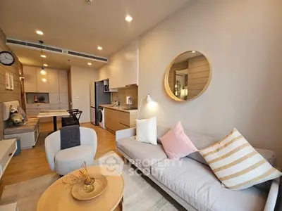 Modern living room with cozy seating and stylish decor in open-plan apartment.