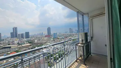 Stunning cityscape view from a high-rise balcony with modern railing.