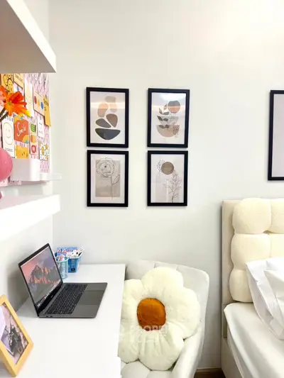 Cozy bedroom corner with modern decor and laptop workspace