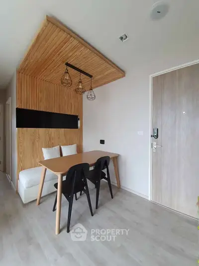 Modern dining area with wooden accents and stylish lighting in a contemporary apartment.