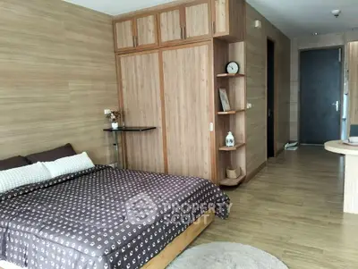 Cozy bedroom with wooden accents and modern decor, featuring a comfortable bed and ample storage space.