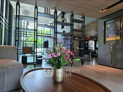 Luxurious modern living room with elegant decor and large windows offering natural light.