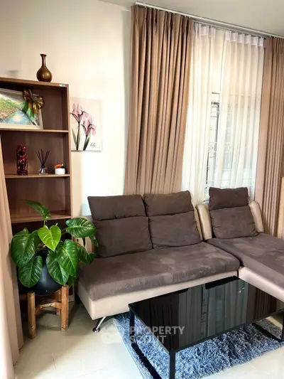 Stylish living room with modern sofa, elegant curtains, and chic decor