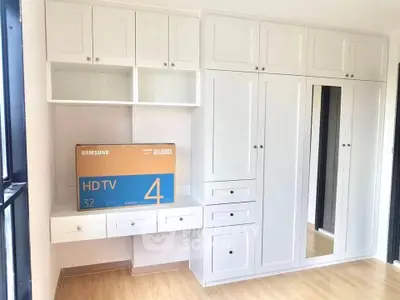 Spacious bedroom with built-in white wardrobes and natural light