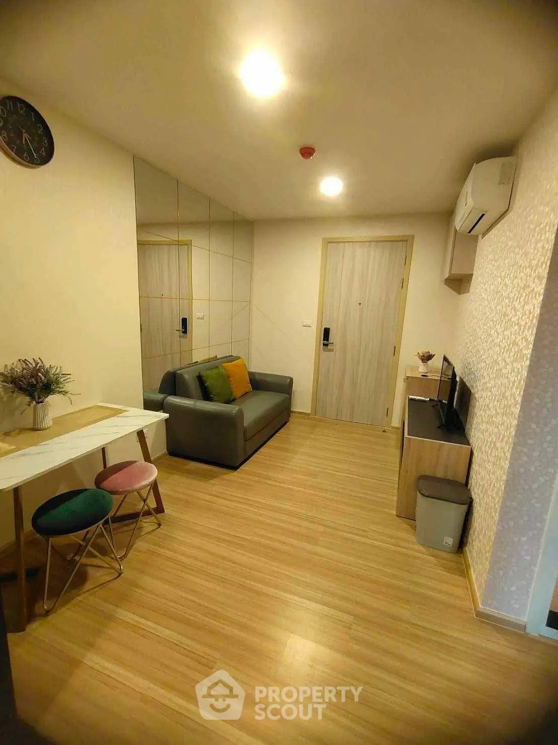 Modern living room with stylish decor and wooden flooring in a cozy apartment.