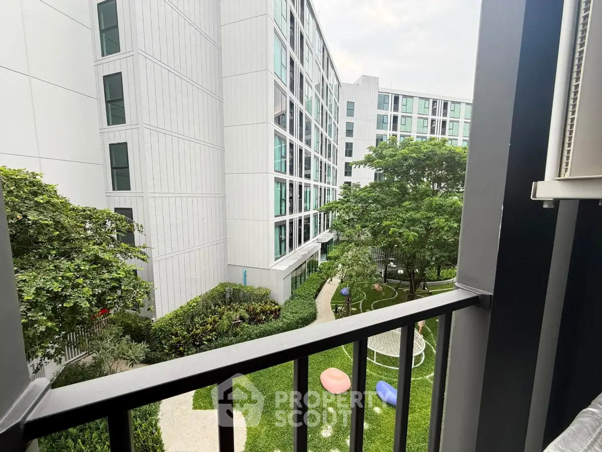 Modern apartment complex with lush garden view from balcony