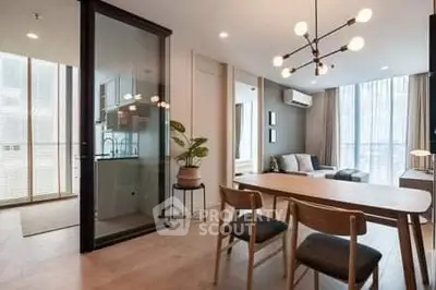 Modern living room with stylish furniture and large windows offering natural light.