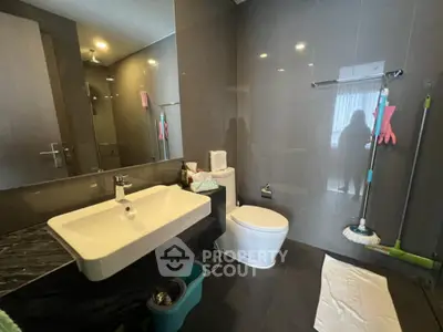 Modern bathroom with sleek fixtures and dark tile flooring