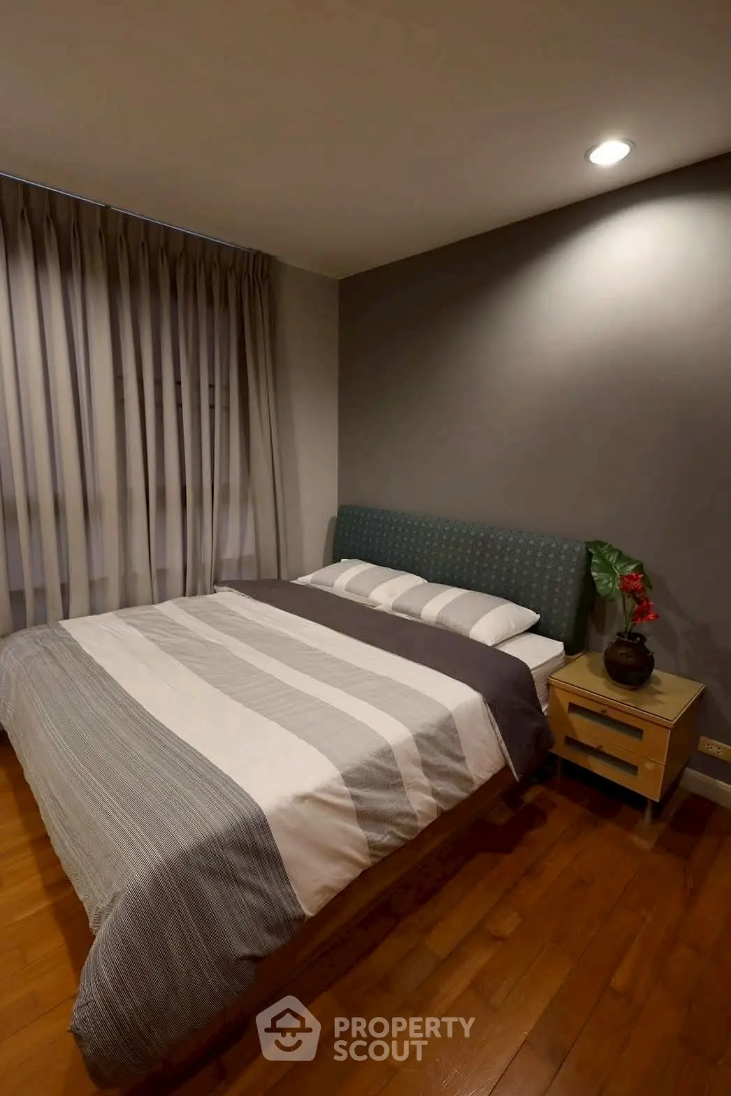 Cozy bedroom with modern decor and soft lighting, perfect for relaxation.