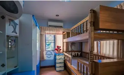 Charming children's bedroom with wooden bunk beds and playful decor
