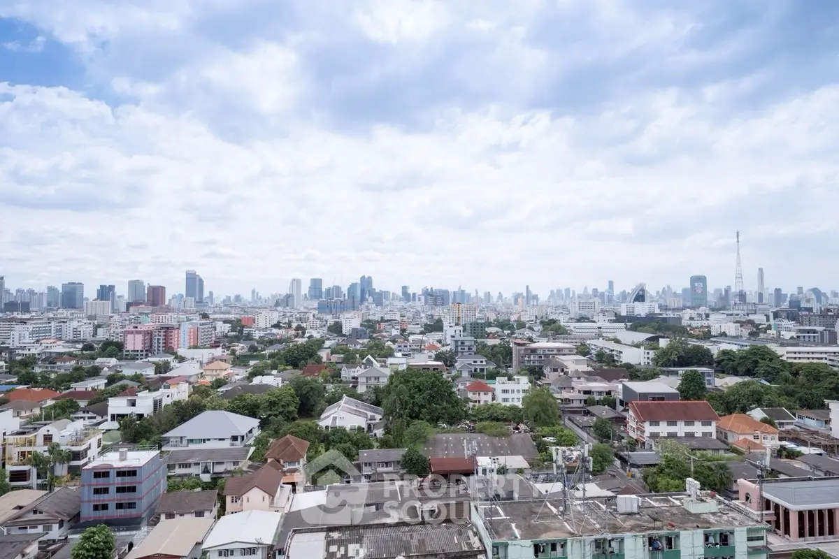 Stunning panoramic cityscape view showcasing vibrant urban skyline and residential areas under a bright blue sky.