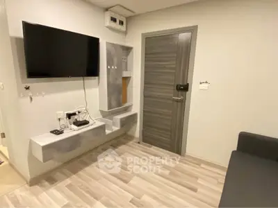Modern living room with wall-mounted TV and sleek storage units