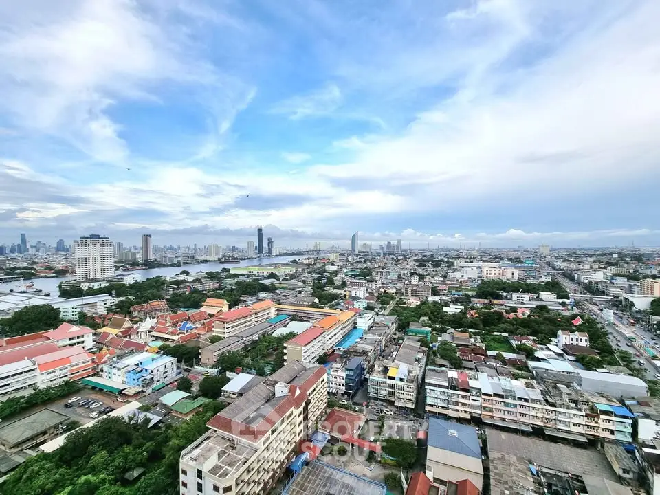 Stunning panoramic cityscape view from high-rise building, showcasing urban skyline and river.