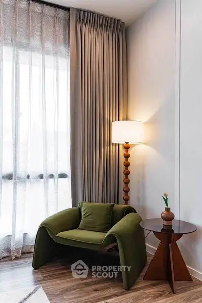 Stylish modern living room corner with designer chair and elegant floor lamp.