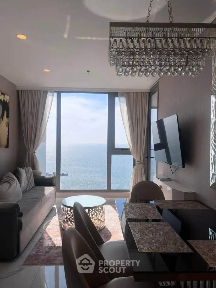 Luxurious living room with stunning ocean view and elegant chandelier