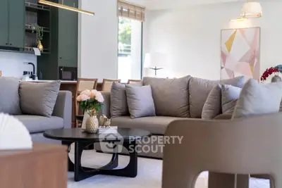 Elegant living room with modern furniture and stylish decor, featuring a cozy seating area and contemporary art.