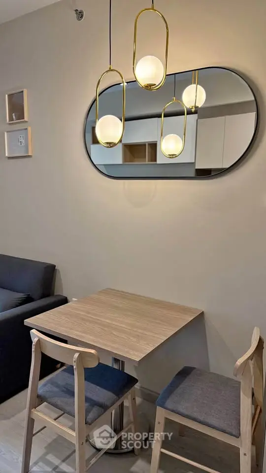 Chic modern dining nook with stylish pendant lights and cozy seating in a contemporary apartment.