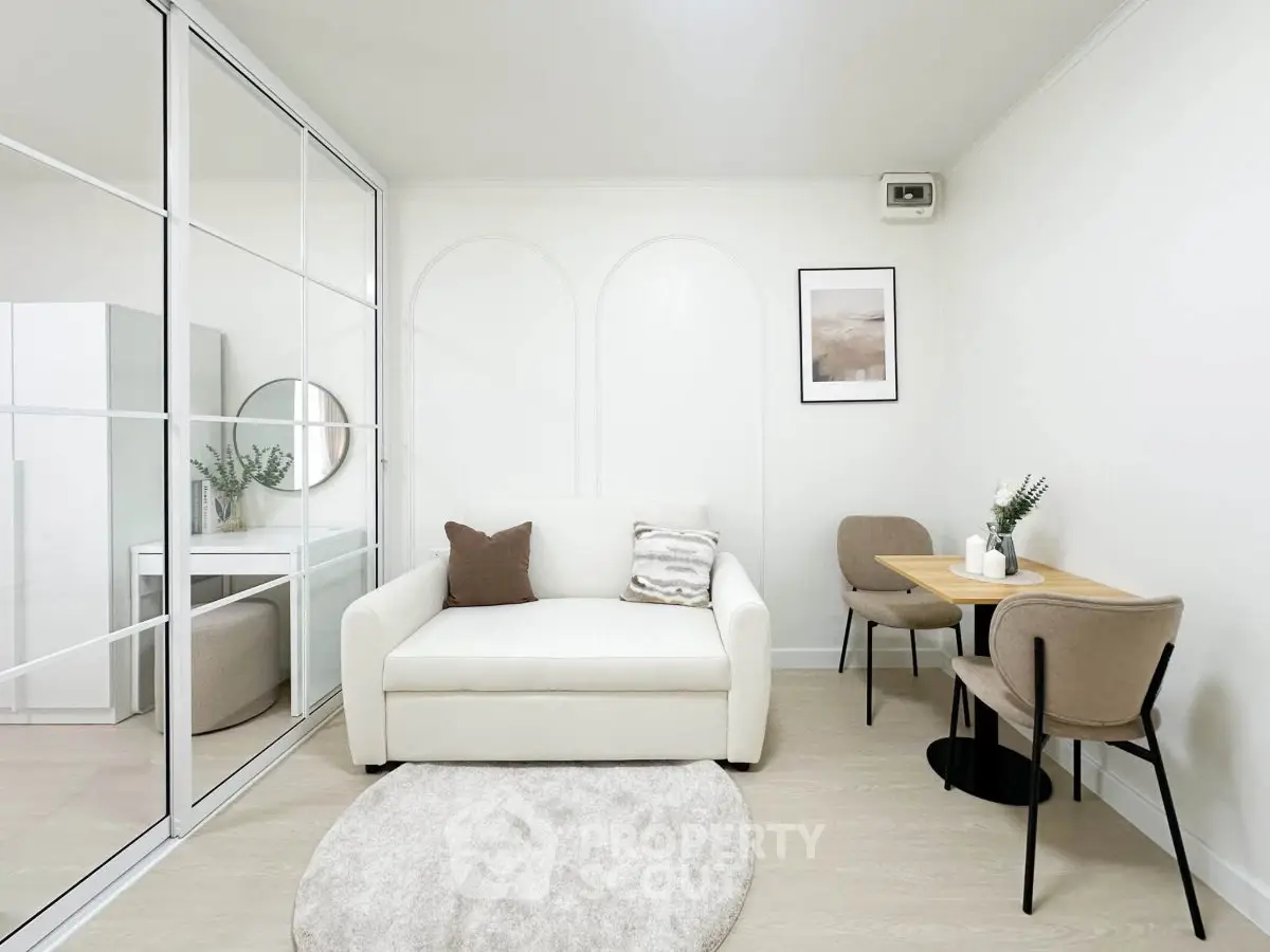 Chic modern living room with white sofa, stylish decor, and cozy dining area.