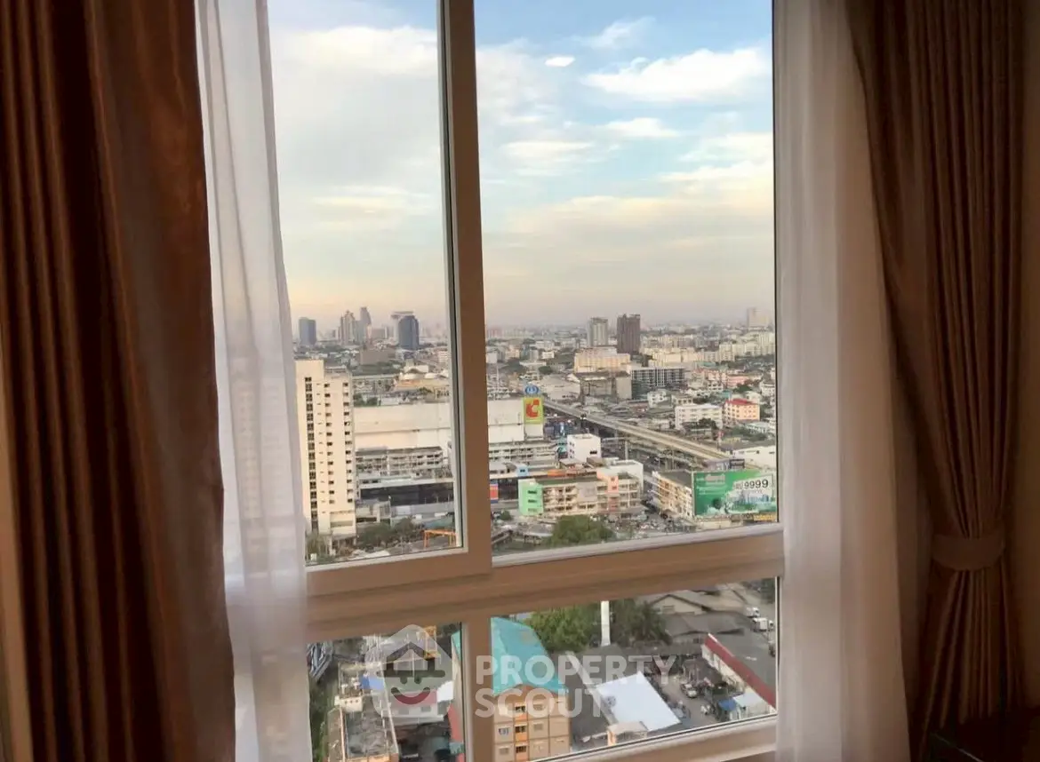 Stunning cityscape view from high-rise apartment window with elegant curtains.