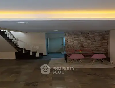 Spacious living area with modern decor and stylish dining set