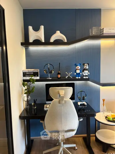 Modern home office with sleek desk, ergonomic chair, and stylish decor on blue accent wall.