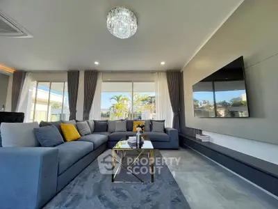Luxurious modern living room with elegant chandelier and large sectional sofa