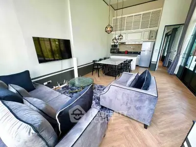 Luxurious open-plan living room with modern kitchen, stylish furniture, and elegant lighting.
