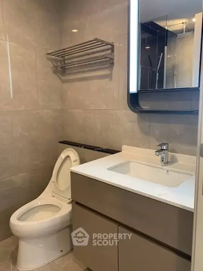 Modern bathroom with sleek fixtures and elegant lighting in a contemporary apartment.