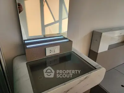 Modern bedroom vanity with marble accents and built-in lighting