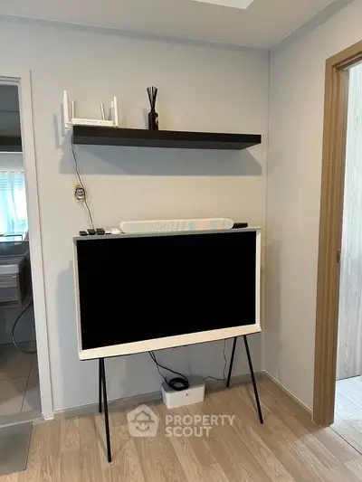 Modern interior with stylish TV stand and shelf in a cozy living space.