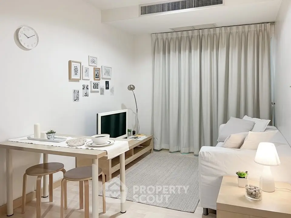 Chic modern living room with cozy white sofa and stylish decor, perfect for relaxation and entertainment.