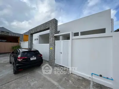 Modern minimalist house exterior with stone accents and driveway