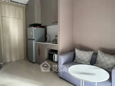 Cozy modern studio with compact kitchen and comfortable seating area