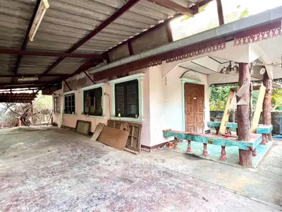 Charming rustic house exterior with covered patio and wooden accents