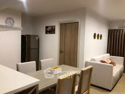 Modern dining area with stylish furniture and cozy ambiance in a contemporary apartment.