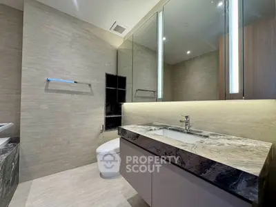 Luxurious modern bathroom with marble countertop and elegant lighting