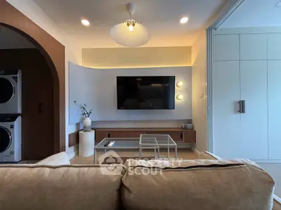 Modern living room with stylish decor and wall-mounted TV