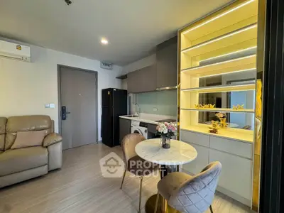 Modern living room with cozy seating, stylish dining area, and sleek kitchen appliances in a compact open layout.