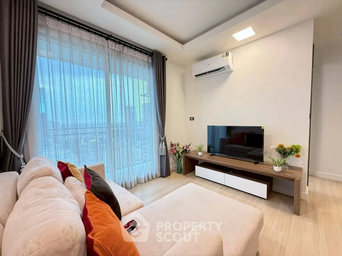 Modern living room with city view, cozy sofa, and stylish decor