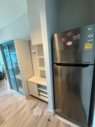 Modern kitchen with stainless steel fridge and sleek storage solutions